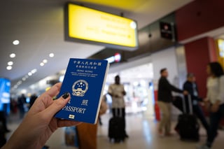 Close Up Of Woman Holding A Passport Of South Korea At The Airport