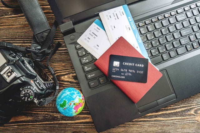Booking Flights And Paying With A Credit Card Using A Laptop