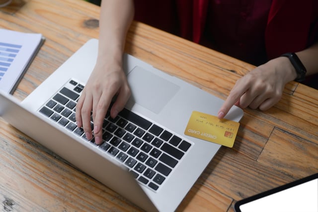 Woman Paying Online Using Laptop