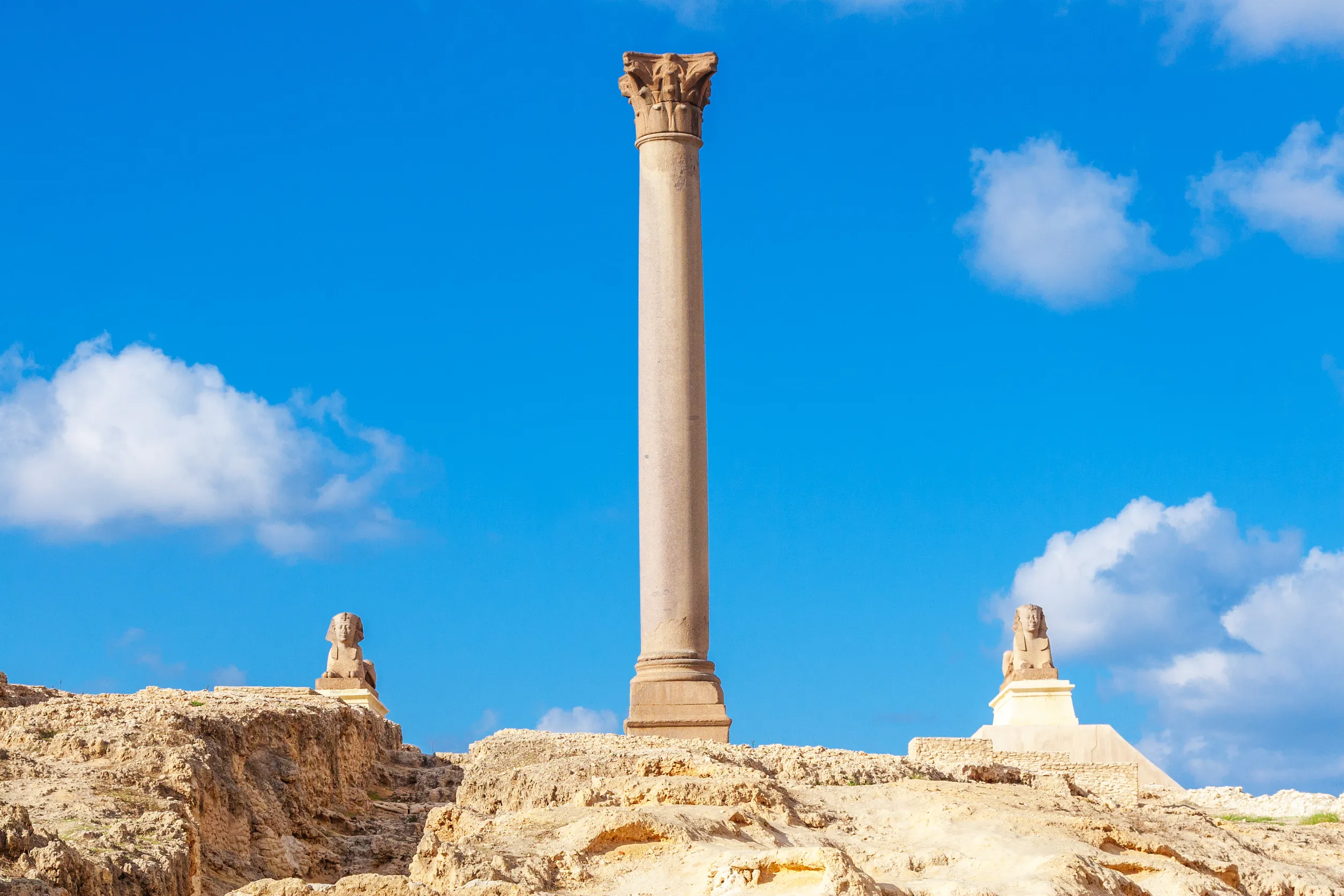 pompey s pillar and ancient sphinx statue roman triumphal column in alexandria egypt
